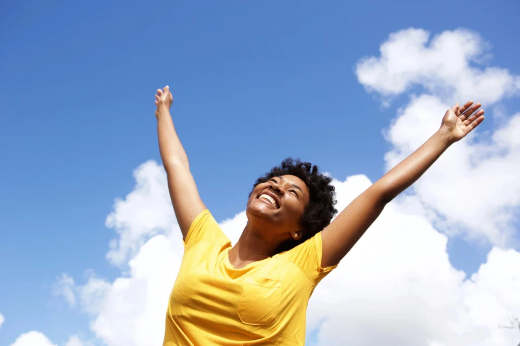 woman smiling comfidently stretching arms cosmetic dentists in Arlington